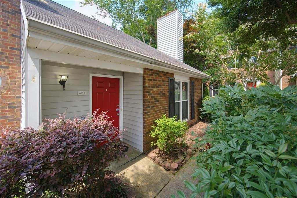 Cottage-style home with red front door
